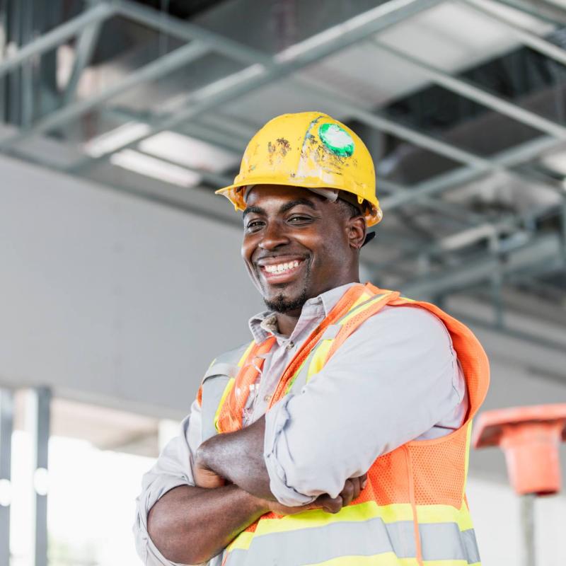Person in construction equipment smiling