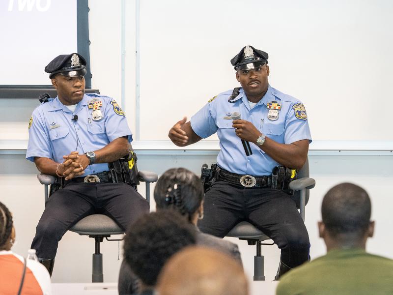 Two officers speaking to a class