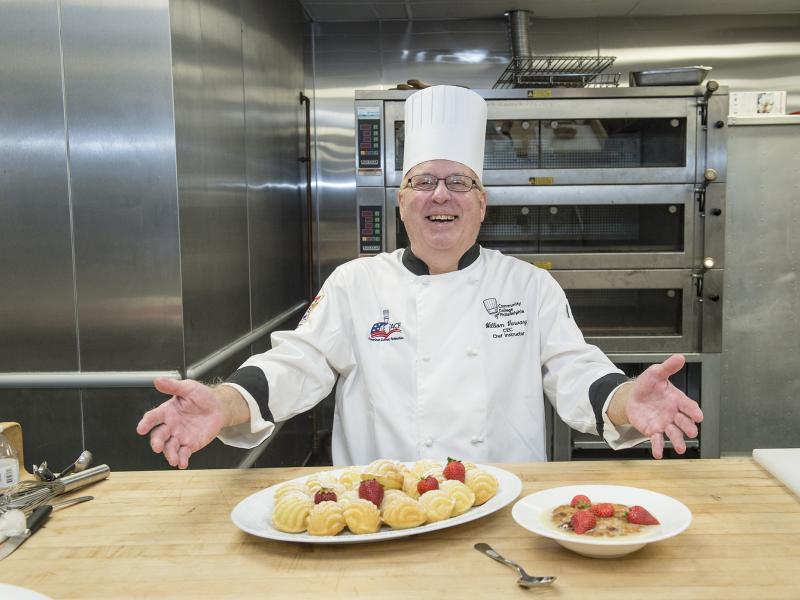 Chef smiling with pastries