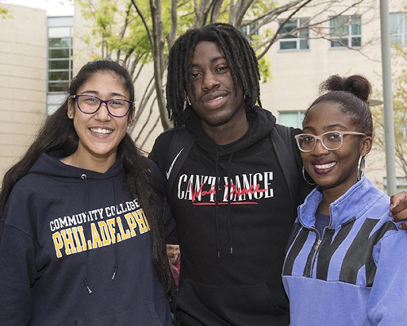Three smiling students outside on Main Campus