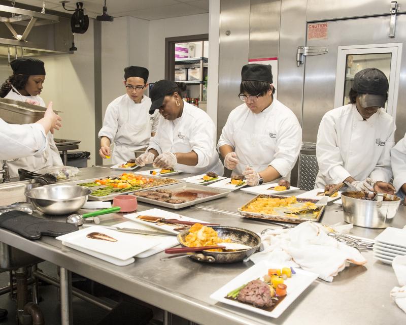 Group of student chefs preparing food
