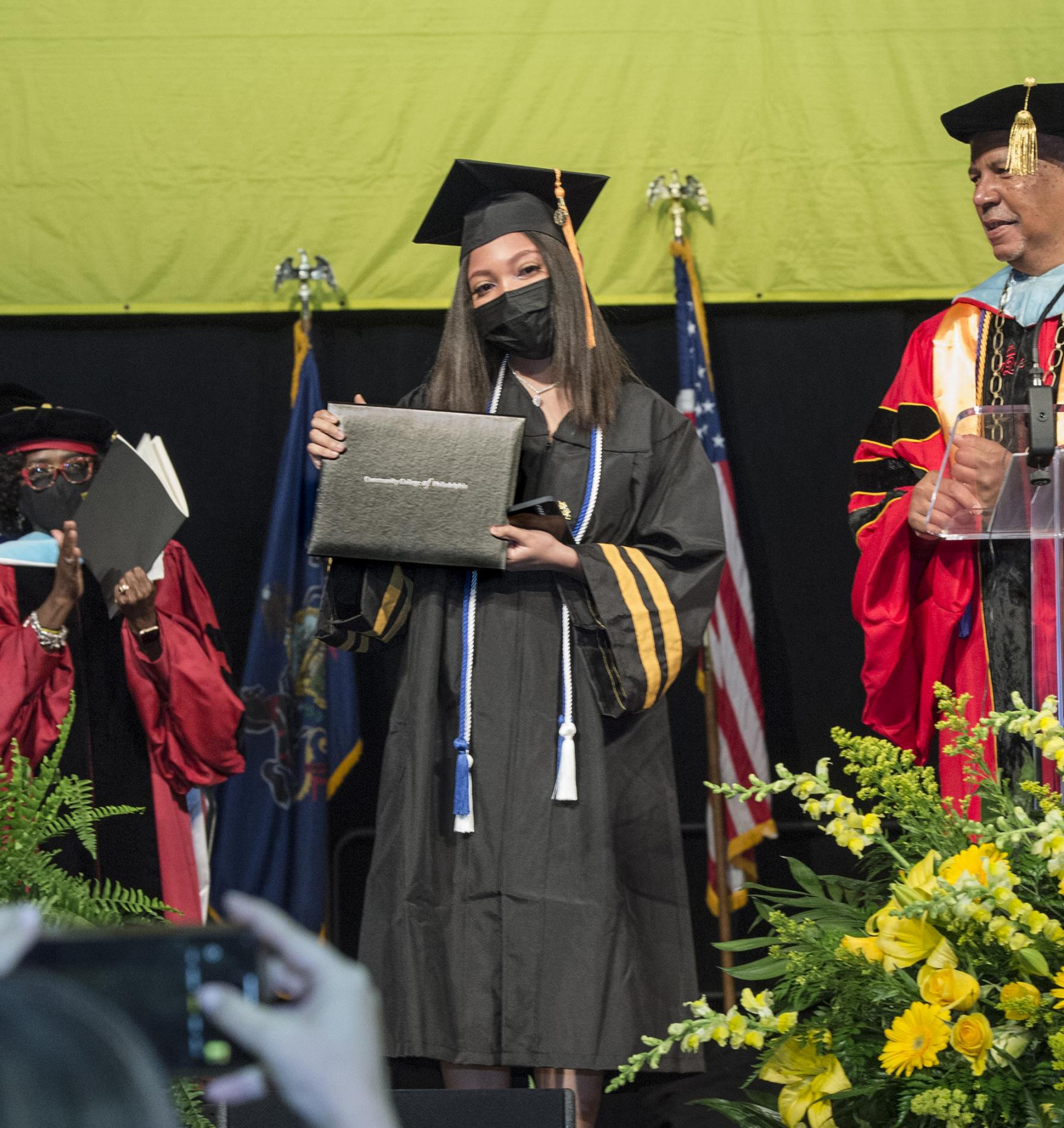 Tahara walking across the stage to get her diploma