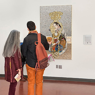 2 people looking at artwork on campus