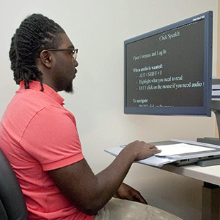 Student using large text reading machine in C.O.D.