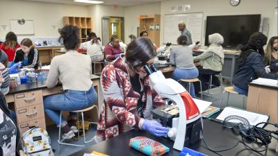 student looking in a microscope