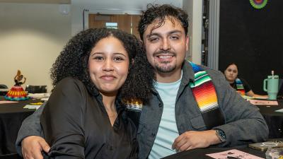 Two students attending a Latine event at the College.