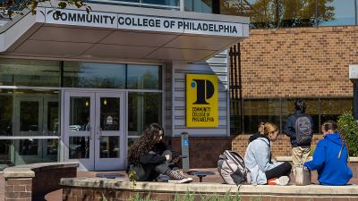 Students sitting outside of the Northeast Regional Center main entrance