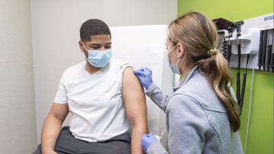 student getting a flu shot