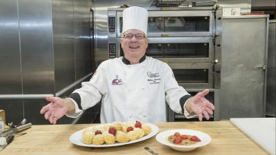 Chef smiling with pastries