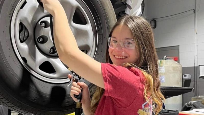 Taya Botte working on a car 