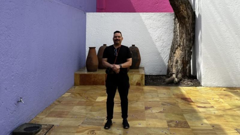  Ariel Vazquez picture in front of a colorful wall and a tree