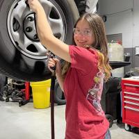 Taya Botte working on a car 