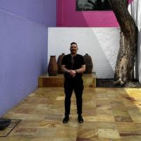  Ariel Vazquez picture in front of a colorful wall and a tree