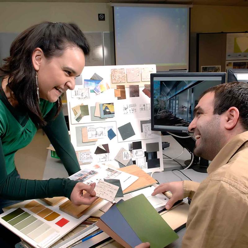 Student and Teacher choosing from material samples and smiling