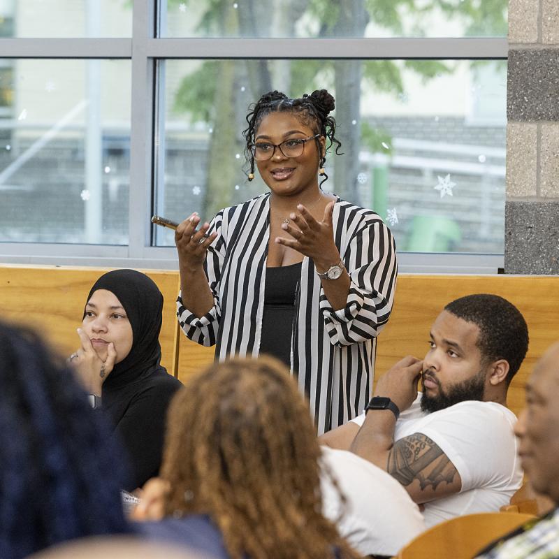 Woman talking to a room of people (BHHS)