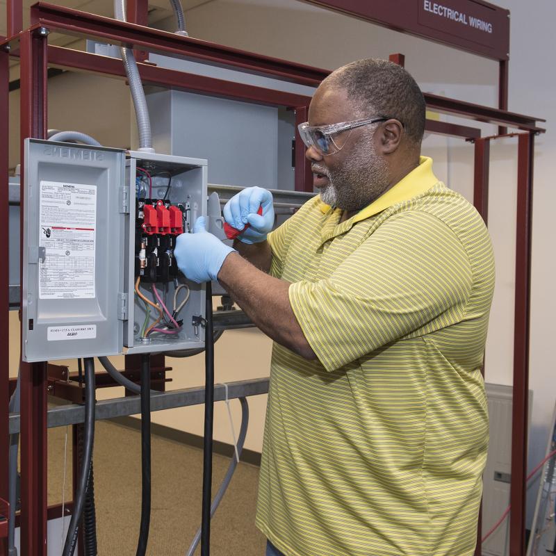 Man working on electrical appliance