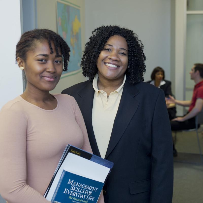 office workers in suits smiling at the camera