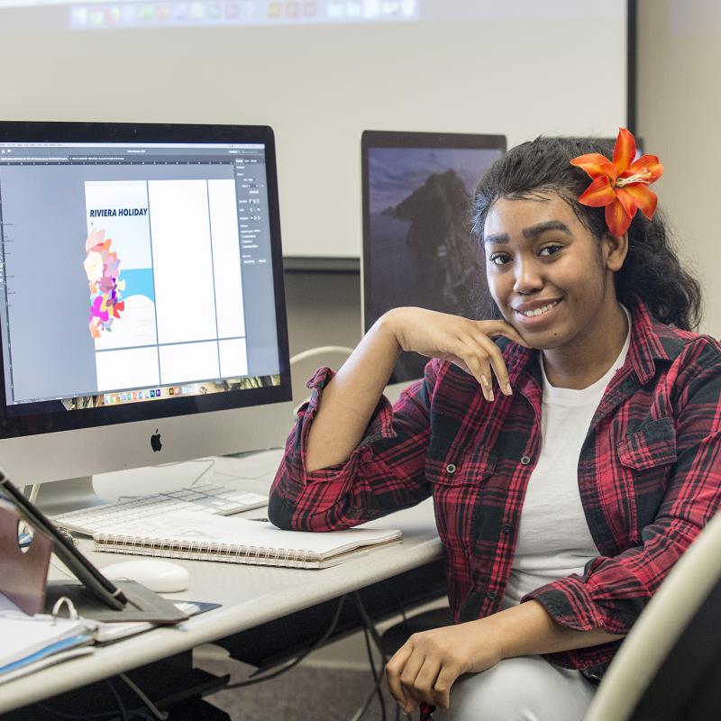 graphic designer sitting at a computer 
