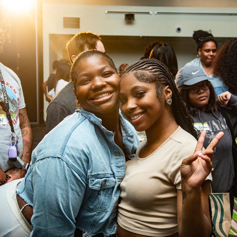 two students smiling at the camera