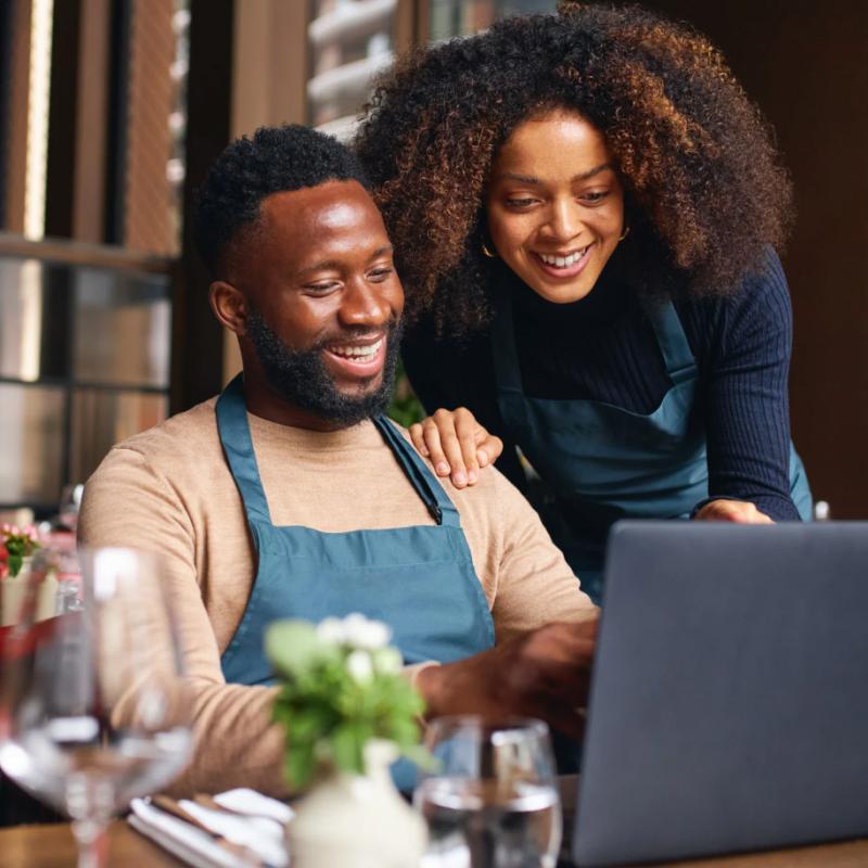 Small Business Owners Looking at a Laptop