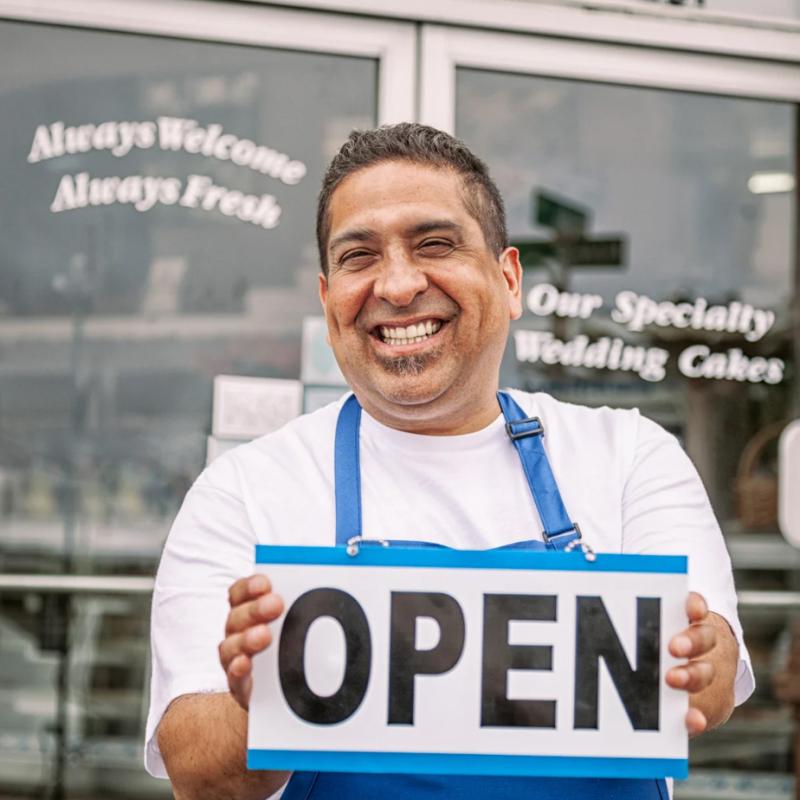 Small Business Owner Holding an Open Sign