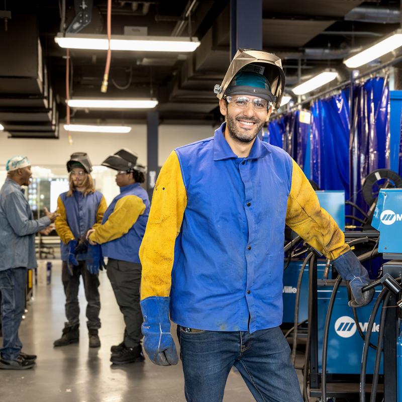 Student in welding class smiling