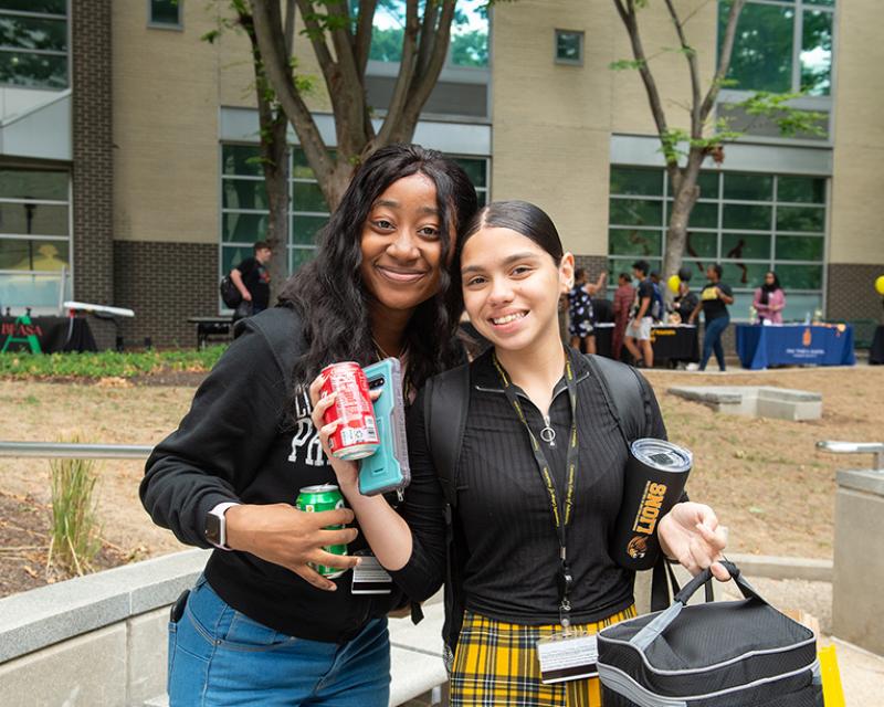 Two smiling students at the Black & Gold Bash on Main Campus