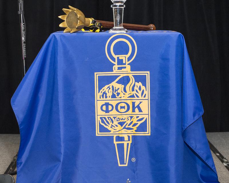 Phi Theta Cappa Logo on a podium
