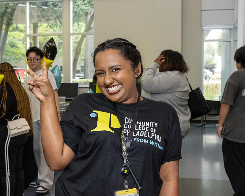 happy student doing peace sign