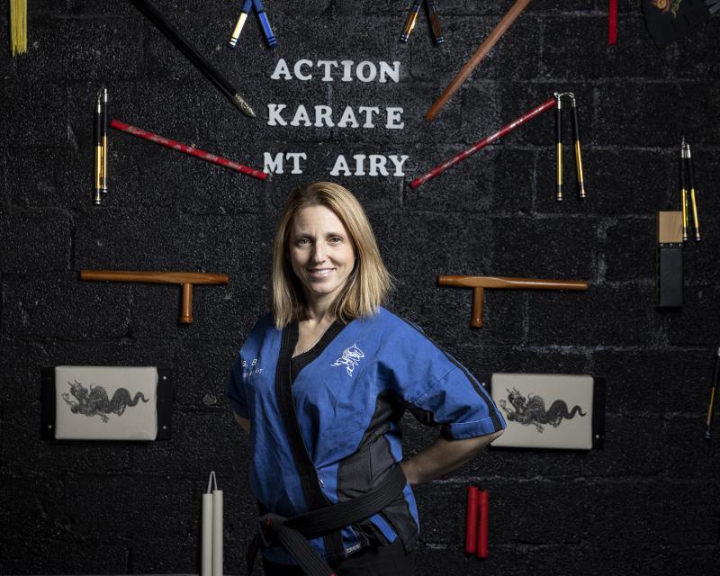 Action Karate Mt Airy owner smiling in her business
