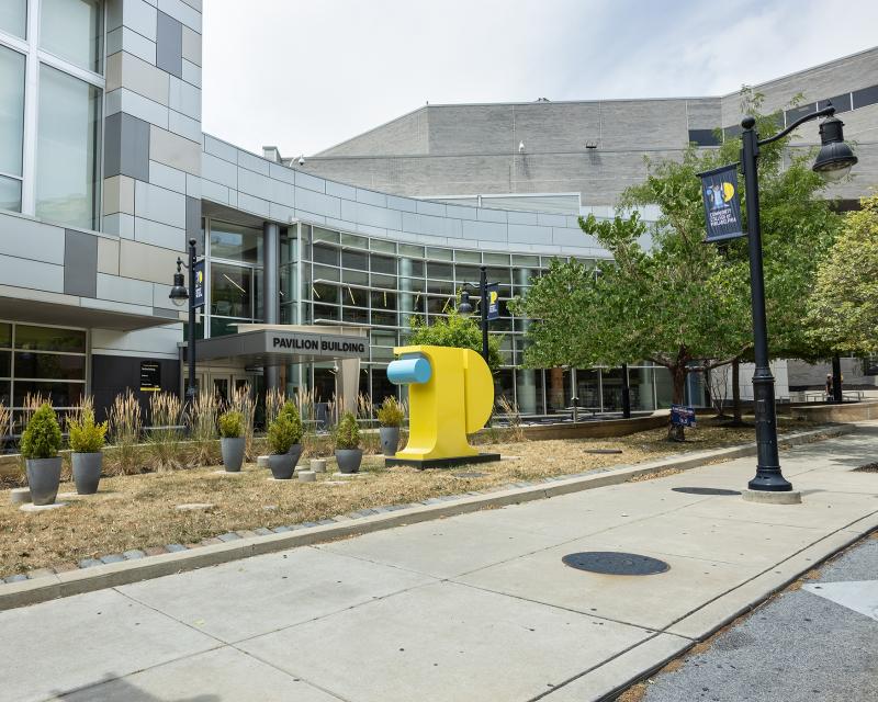 Exterior view of Pavilion Building with 3D College logo icon in forefront