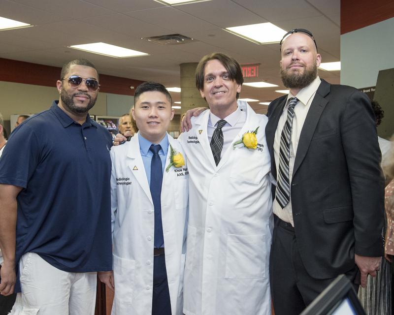 DMI students with their loved ones smiling at the camera