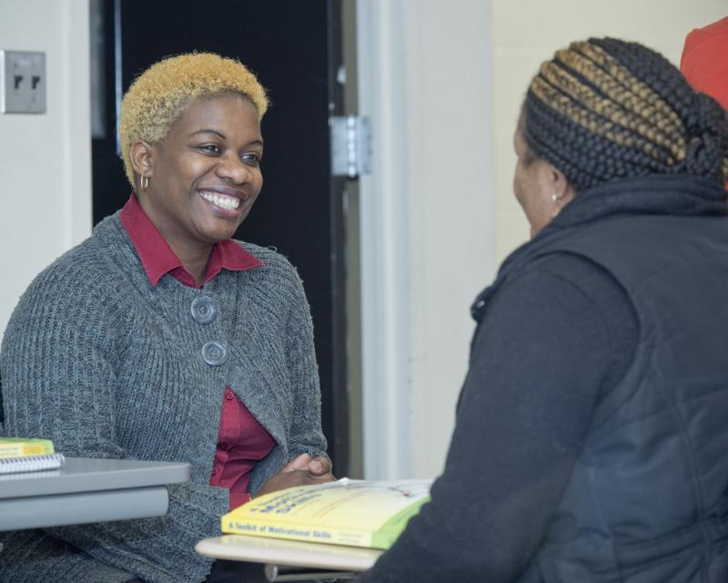 Two women communicating with one another in class