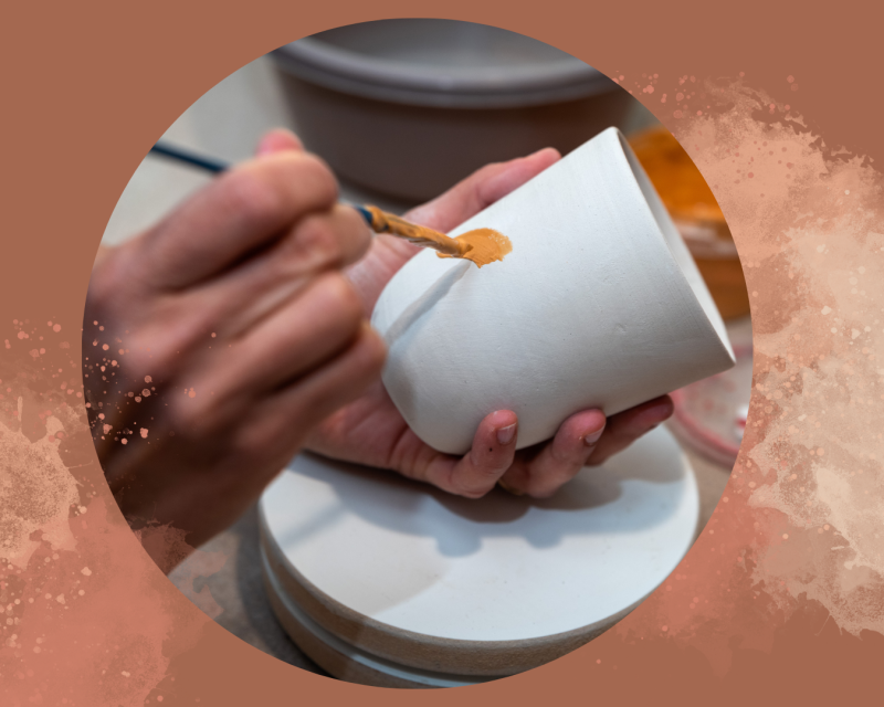 student painting pottery