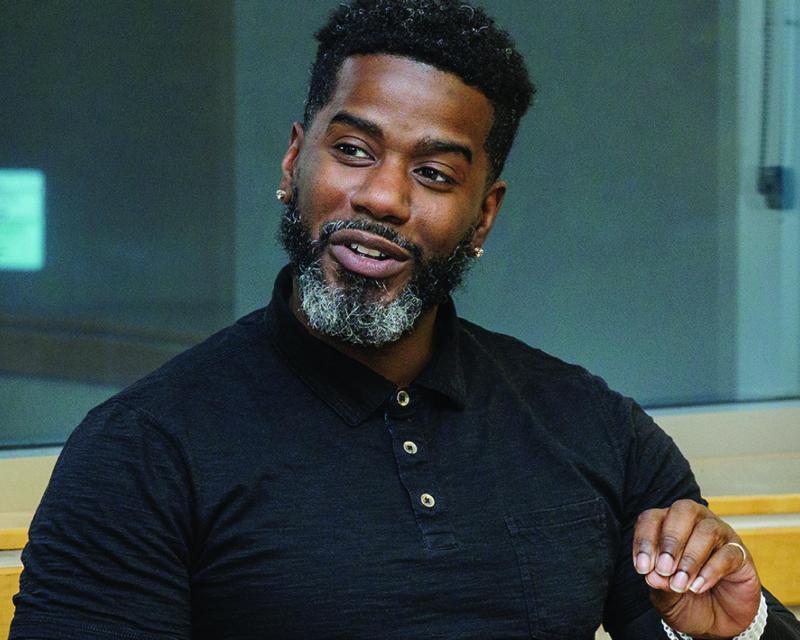 Male student in a classroom discussion.