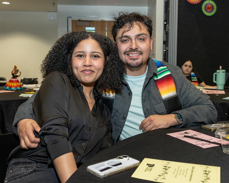 Two students attending a Latine event at the College.