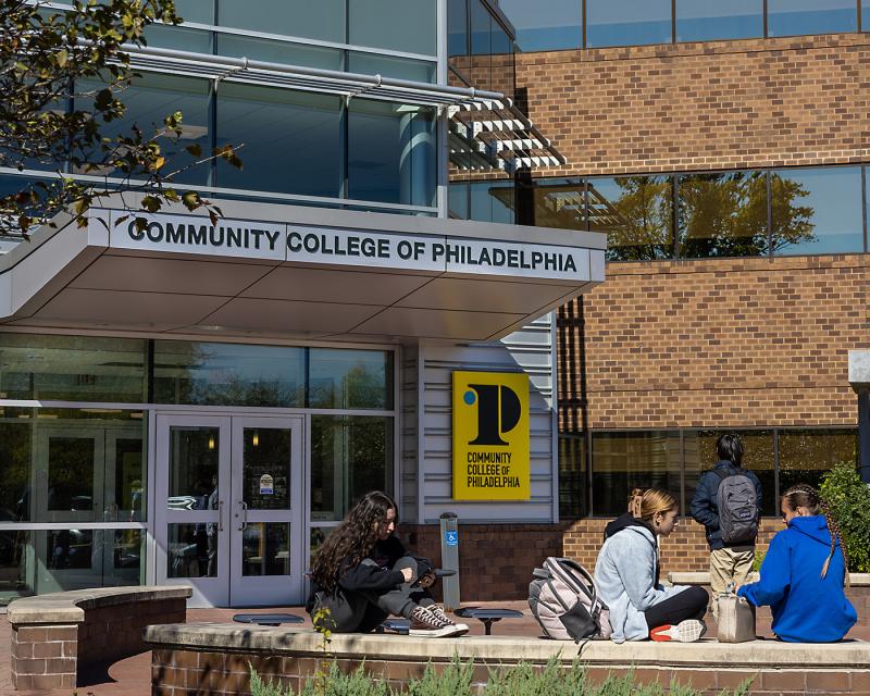 Students sitting outside of the Northeast Regional Center main entrance