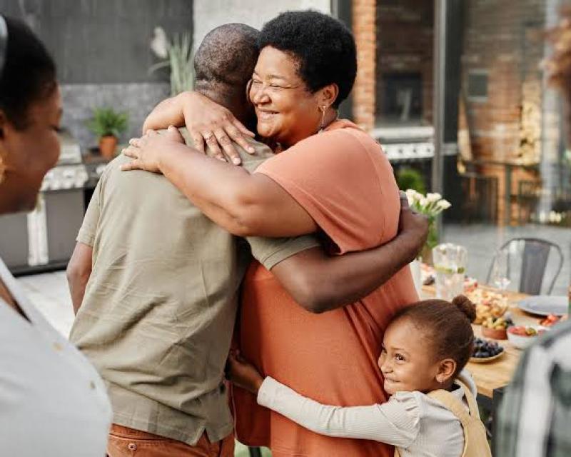 A family embraced in a group hug.