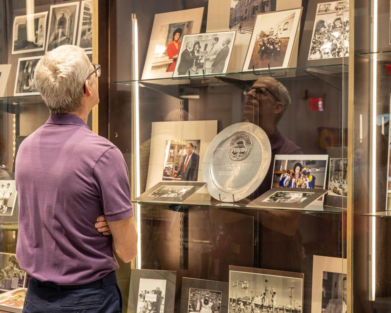 Faculty member looking at the 60th display