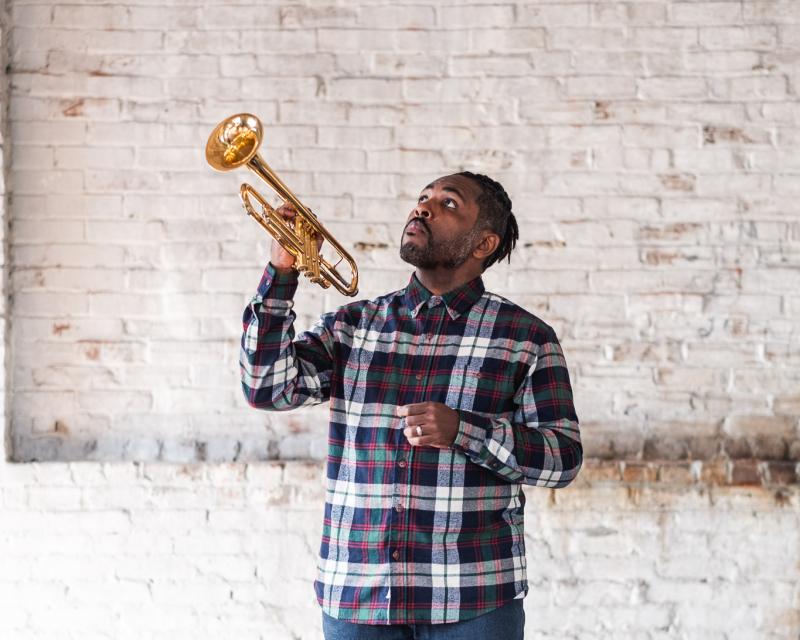 Christopher Michael Stevens posing with a trumpet