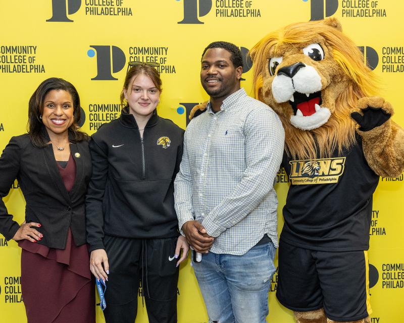 Jack Kent Cooke Scholars posing for a picture with Roary and Dr. Alycia Marshall, Interim President of the College
