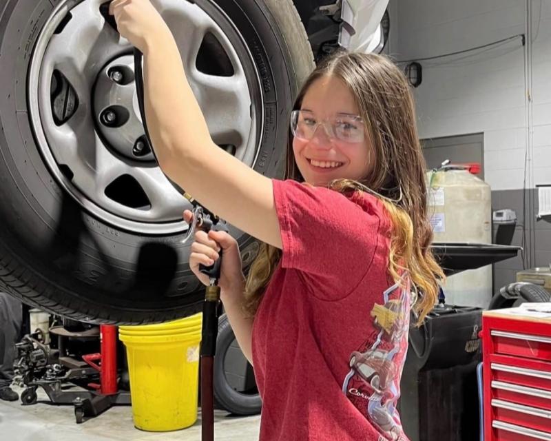 Taya Botte working on a car 