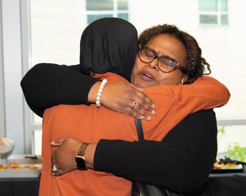 Two women hugging one another in support