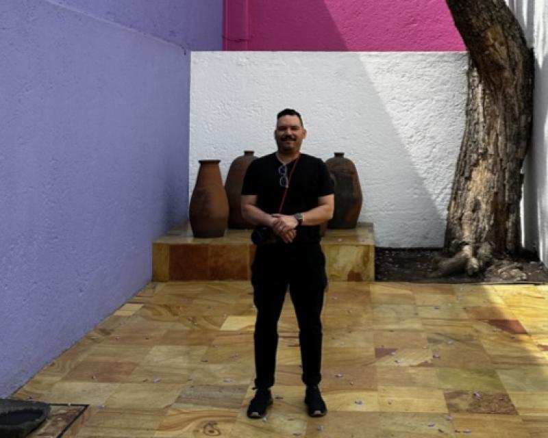  Ariel Vazquez picture in front of a colorful wall and a tree