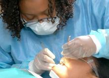 CCP student performing dental checkup in clinic. 